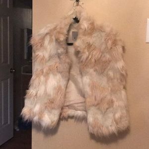 Faux fur vest with single hook closure.